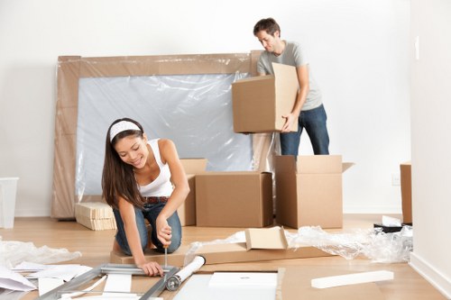 Removal team using safe lifting practices during a house move