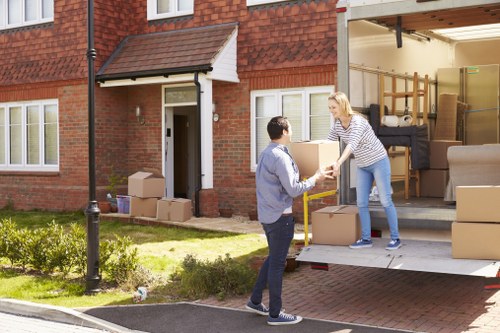 Local moving team handling furniture and boxes with a removal van