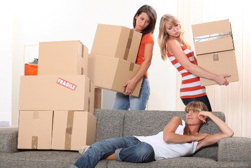 Removal crew handling desks and office furniture with care